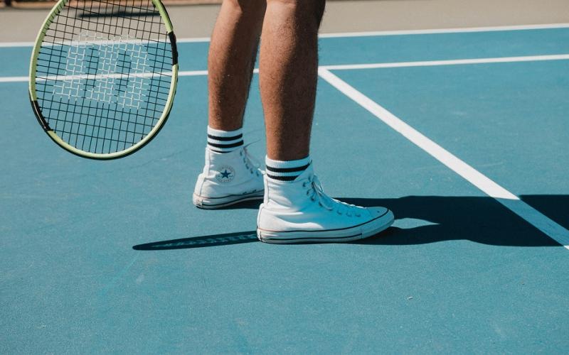 a tennis player is standing on the court