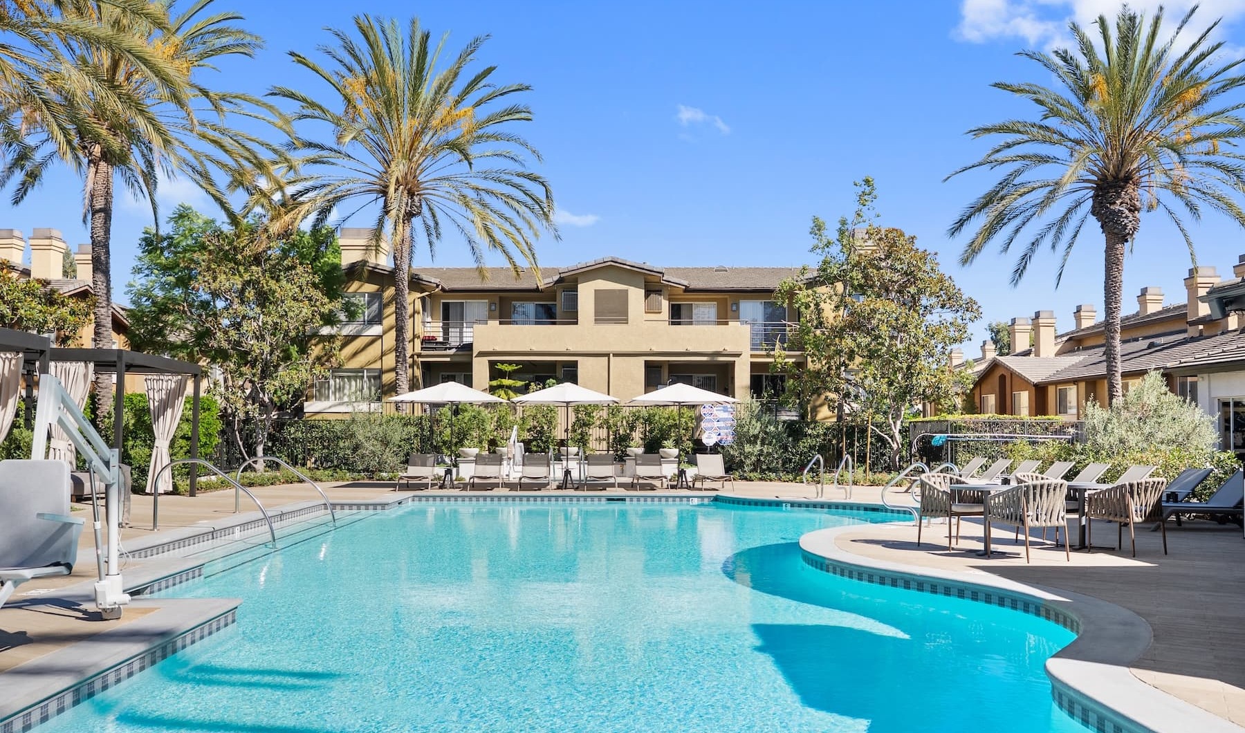 a pool with trees and buildings in the background